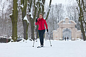 Female cross-country skier in riparian forest, Leipzig, Saxony, Germany