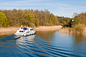 Houseboat on the waterway from lake Grosser Zechliner See to the Huetten kanal, near Zechlinerhütte, North Brandenburg Lake District, Brandenburg, Germany