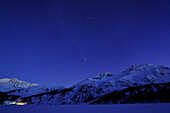 Night sky above snow-covered lake Silser See, with view to Bernina range, lake Silser See, Upper Engadin, Engadin, Grisons, Switzerland, Europe