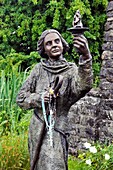 St Brigid’s holy well, early pagan and Celtic Christian site near town of Kildare, Co Kildare, Ireland Statue of St Brigid