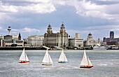 Liverpool Pier Head buildings The Three Graces across the River Mersey, England Regatta sailboat dinghies