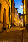 Cobbled street in the old town at night, Stockholm, Sweden