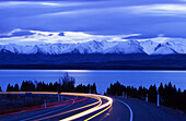Traffic on State Highway 8 with view to Ben Oahu range, Lake Pukaki, South Island, New Zealand