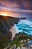 View along rugged coastline at sunrise, Porthcurno, Cornwall, UK - England