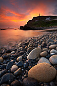 View from stony beach at sunset, Cape Cornwall, Cornwall, UK - England