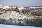 Castle and village in winter, Corfe Castle, Dorset, UK - England