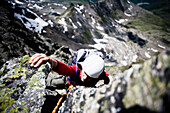 Woman on southeast ridge of mount Grosslitzner, Silvretta mountain range, Vorarlberg, Austria