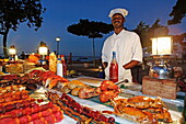 Monger at a stand, night market at Forodhani Gardens, Stonetown, Zanzibar City, Zanzibar, Tanzania, Africa