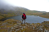 Ascent to Glyder Fawr, view to lake Cwm Idwal, Snowdonia National Park, Wales, UK