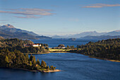 Morning light at Lago Moreno, view to an hotel and the Lago Nahuel Huapi, near San Carlos de Bariloche, Rio Negro, Patagonia, Argentina