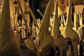 Nazarenos of the brotherhood La Borriquita during procession on Palm Sunday, Semana Santa, Sevilla, Andalusia, Spain, Europe