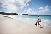 Tourist with snorkelling gear on Middle Island beach, Island next to Great Keppel Island, Great Barrier Reef Marine Park, UNESCO World Heritage Site, Queensland, Australia