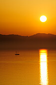 Sailing ship at sun set in Mediterranean, island of Corsica in background, Fetovaia, island of Elba, Mediterranean, Tuskany, Italy