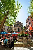 People sitting at a    sidewalk cafe in Corniglia, Corniglia, Cinque Terre, UNESCO World Heritage Site Cinque Terre, Mediterranean, Liguria, Italy