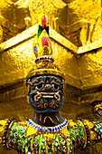 Thailand, Bangkok, The Grand Palace Statue in the ornate setting of the golden grand palace