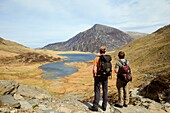 Cwm Idwal, Gwynedd, North Wales, UK, Europe Walkers by Llyn Idwal in the mountains of Snowdonia National Park