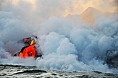 Steam rising off lava flowing into ocean, Kilauea Volcano, Hawaii Islands, United States