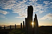 Winter sunrise through Ring of Brodgar standing stones, Orkney, Scotland