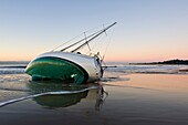 Santa Barbara, California: Sailboat washed ashore on beach during winter storm
