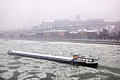 Ice on the frozen Danube and winter snow Budapest .