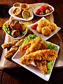 Party buffet food with southern fried chicken, bhajis, mini quiche and deep fried camembert