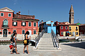 Tourists Strolling Along the Canals on Burano Island in the Lagoon of Venice, Venetia, Italy