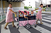 Children in a Stroller Pulled By Day Care Workers on a Pedestrian Crossing, Tokyo, Japan
