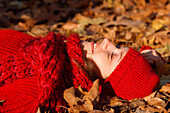 Symbiosis with Nature. a Young Woman Lying on a Carpet of Autumn Leaves