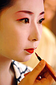 A Maiko (Apprentice Geisha) with Her Traditional Makeup (Doran). Lipstick (Kushibeni) Applied with a Brush, a Small Mouth (Ochobo Kushi) Is a Beauty Criteria, Gion District, Kyoto, Japan, Asia