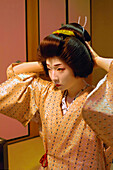The Geiko's (Geisha) Traditional Hairdo: a Wig (Katsura) with a High Chignon Adorned with a Decorated Hairpin (Kanzashi), Gion District, Kyoto, Japan, Asia