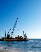 Machinery Cleaning Up a Pier, Bradenton, Florida, United States