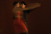 Couple dancing together, blurred motion