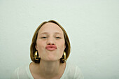 Teen girl puckering lips, portrait