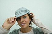 Young woman wearing trendy cap, smiling