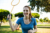 Teen girl playing badminton