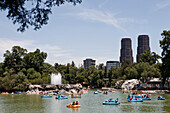 Mexico, Mexico City, tourists boating on lake in Bosque de Chapultepec (Chapultepec Park)