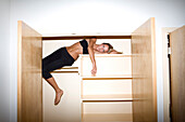 Young Blonde Woman Posing on Closet Shelf