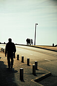 Silhouetted Figures on Street