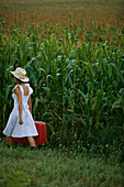 Woman with Suitcase in Corn Field 2