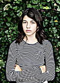 Teenage Girl Against Vine Covered Wall