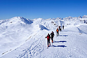 Group of people backcountry skiing ascending the mountain, Villgraten range in the background, Marchkinkele, Villgraten range, Hohe Tauern range, East Tyrol, Austria, Europe