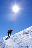 Two people backcountry skiing ascending the mountain, Villgraten range, Hohe Tauern range, East Tyrol, Austria, Europe