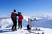 Two people backcountry skiing congratulating each other at the summit, Gaishoerndl, Villgraten range, Hohe Tauern range, East Tyrol, Austria, Europe
