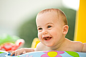 Portrait of a baby in a little pool