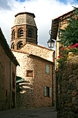 France, Auvergne, Haute-Loire, Lavaudieu, street and bell tower of abbbey church