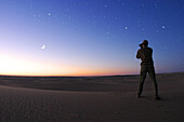Libya, man photographing sky