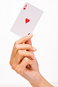 Woman's hand holding a playing card (ace of heart)