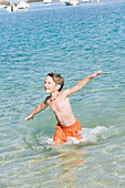 Boy running into sea