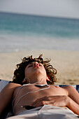 Cape Verde Peninsula, Sal, Santa Maria beach, teen boy with Ipode