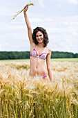 Young woman wearing underwear in wheat field
